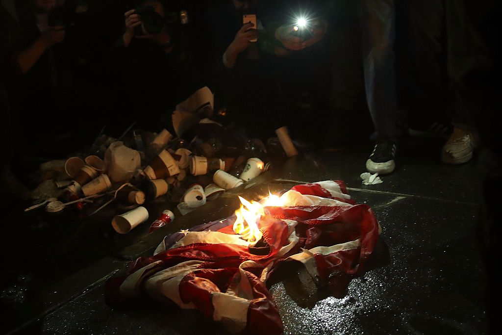 A flag being burned in front of Trump Tower  (Getty Images)